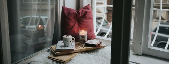 Cosy winter home with candles and blankets