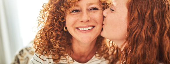 Daughter hugging and supporting mother